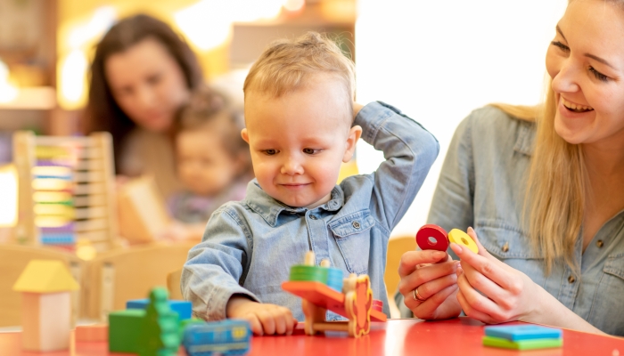 Children kids play with educational toys, arranging and sorting colors and shapes.