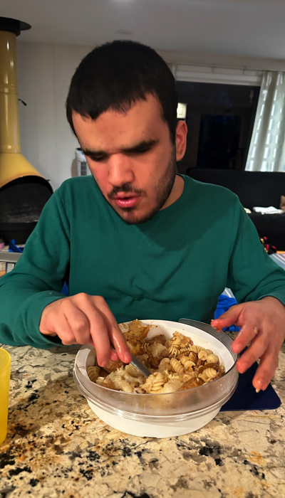 Michael eating with a plate guard.