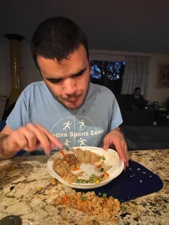 Michael eating with a messy plate.