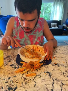 Michael eating with a messy plate.