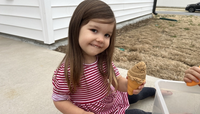 Happy little girl with her beach toy.