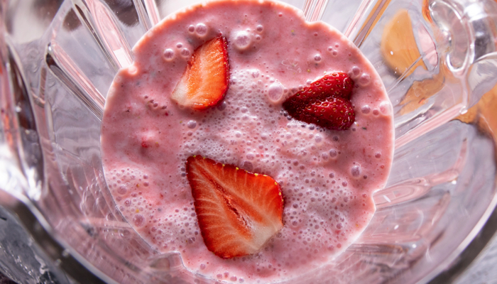 Strawberry smoothie in a blender.