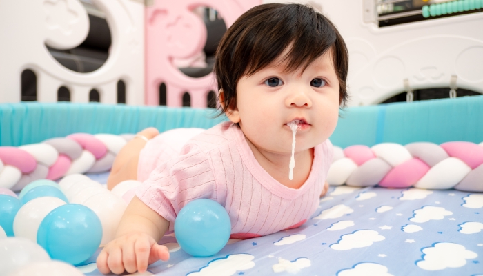 Asian Thai Baby Girl Vomit on Bed after Drink Milk.
