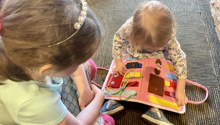Two girls playing montessori toys.