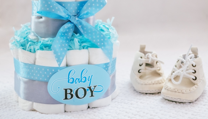 Present cake with diapers for newborn baby boy.