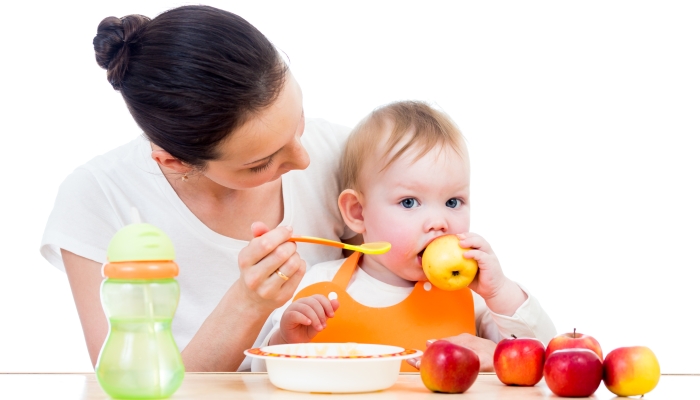 Young mother feeding her baby.