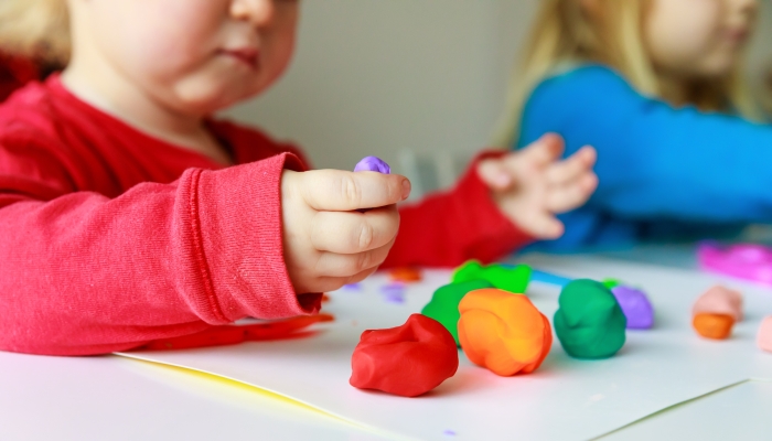 kids play with clay molding shapes.