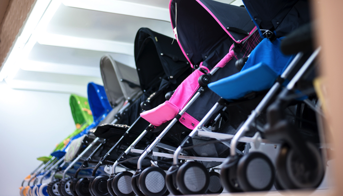 Row of umbrella strollers for sale at the mall.