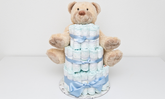 Diaper cake with a teddy bear.