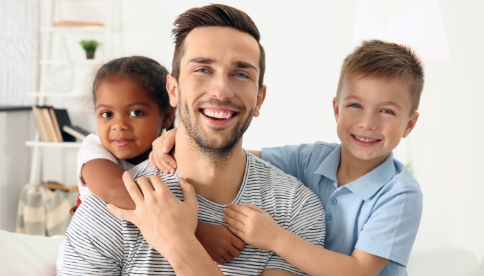 Happy father with interracial children.