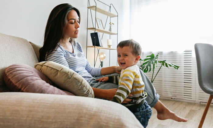 Upset toddler throwing a tantrum at home.