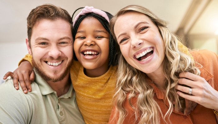 quality time after adoption with mother, father and foster child together in their home.