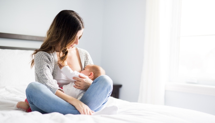 A Young mother holding her baby child.