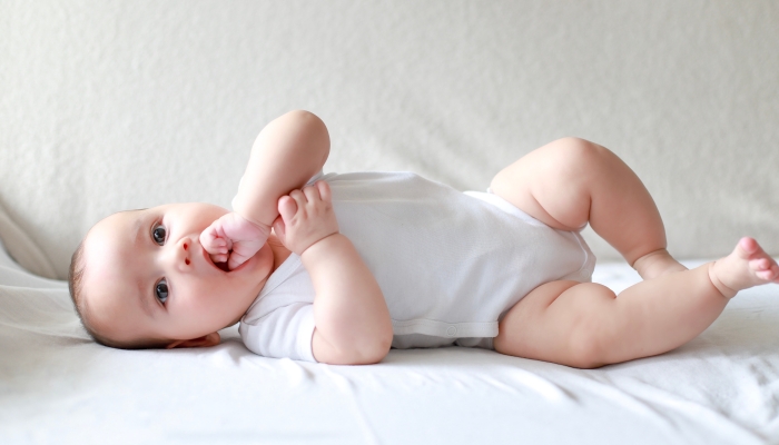 Baby newborn boy sucking finger.