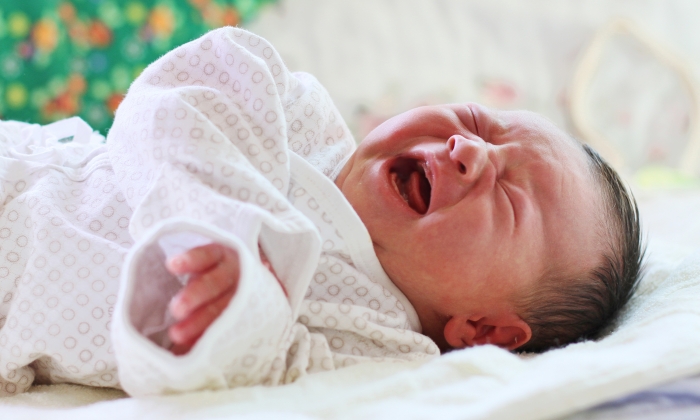 Crying Newborn Baby with narrow focus.