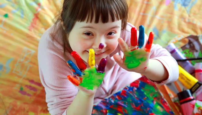 Cute little girl with painted hands.