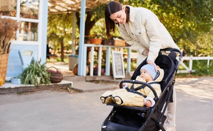 Mom and her little son on a walk at the autumn fair, park.