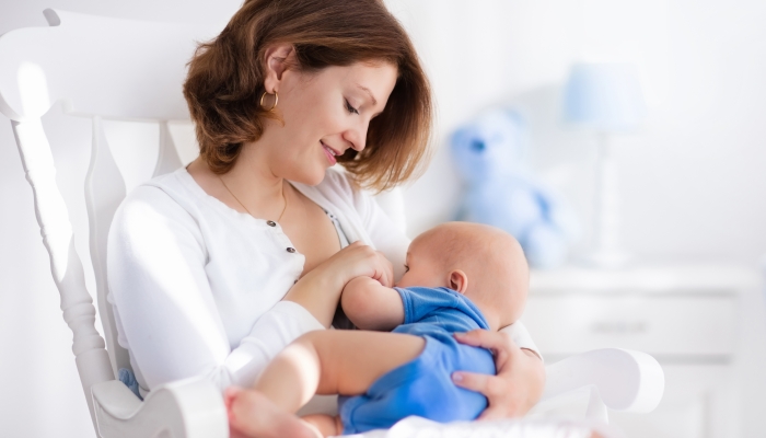 Young mother holding her newborn child.