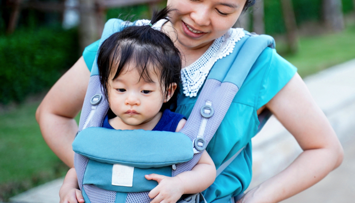 Toddler in a carrier.