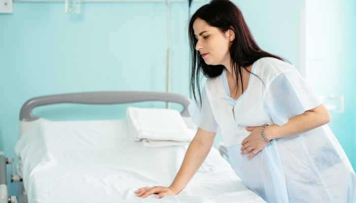 Caucasian pregnant woman having painful contractions before labour.