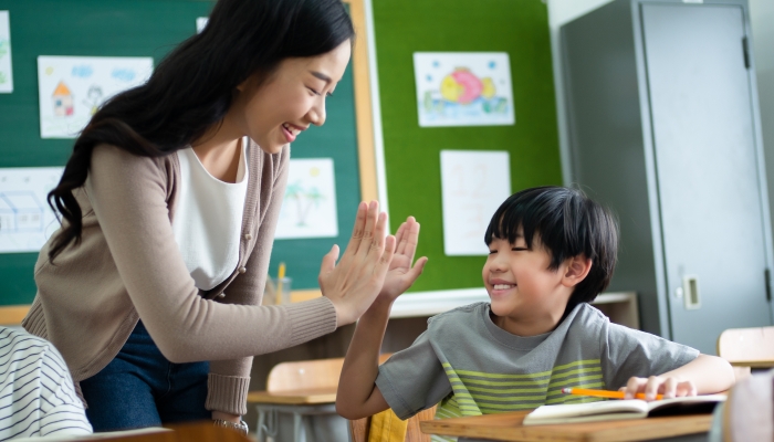 High five gesture team in classroom.