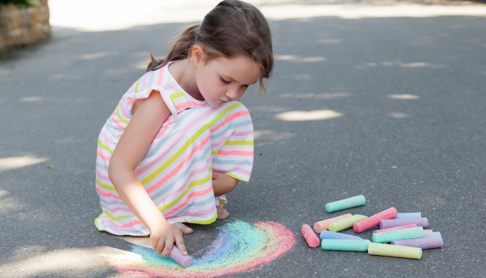 Kids paint outdoors.