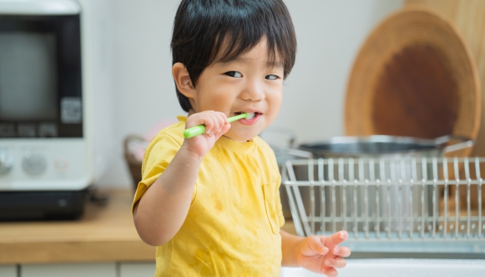 Little cute toddler brushing teeth.