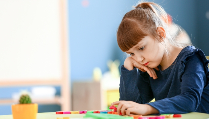 Little girl with autistic disorder in playroom.