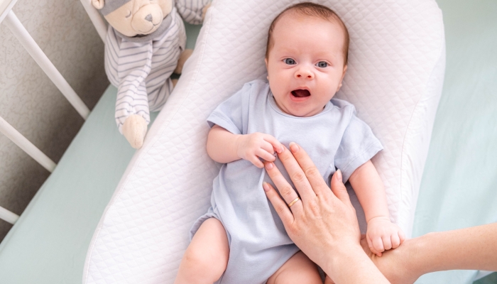 Newborn baby yawns.