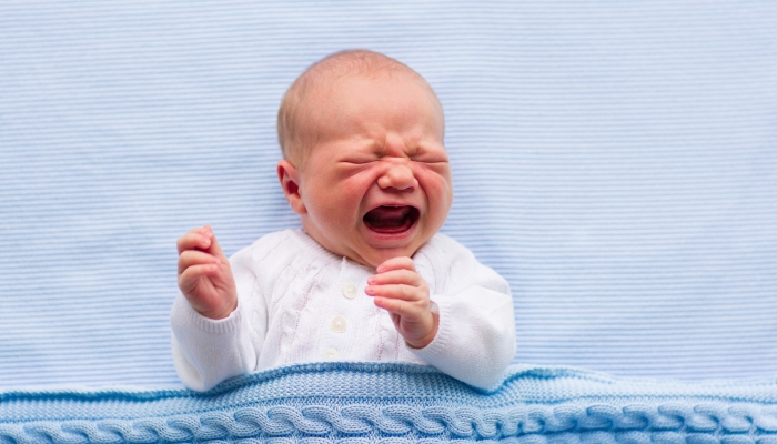 Newborn crying baby boy.