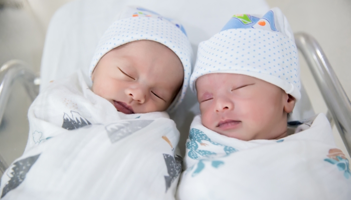 Newborn twins sleeping.