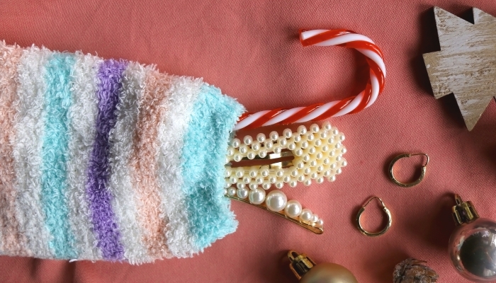 Pastel colored stocking filled with small presents and Christmas decorations.