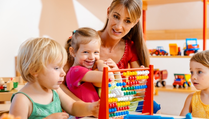 Preschool teacher playing with the children.