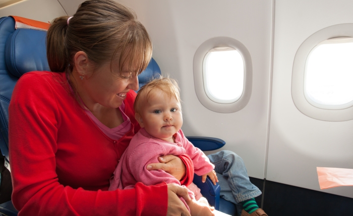 mother and little daughter travel by plane.