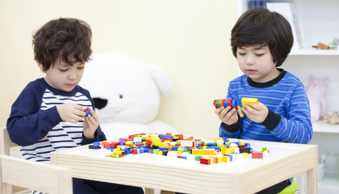 the image of cute Asian kids playing lego.