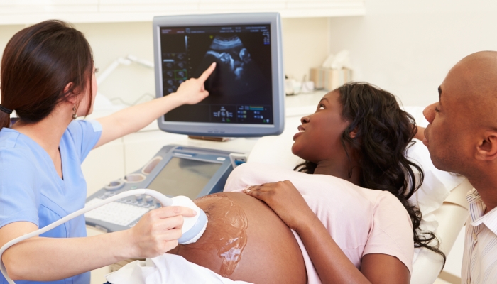 Pregnant Woman And Partner Having 4D Ultrasound Scan.
