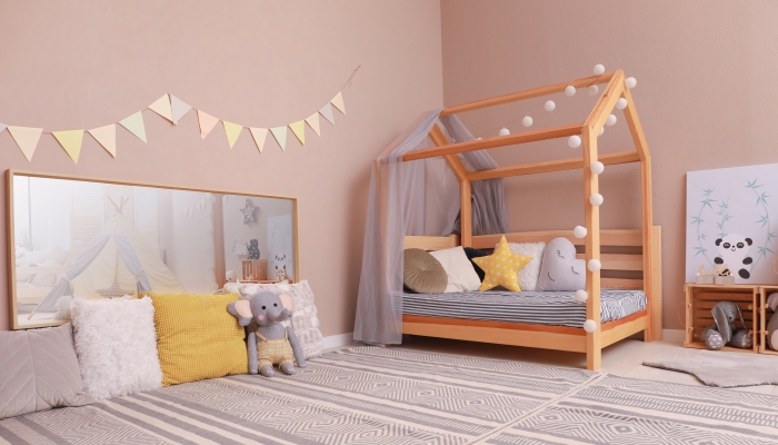 Stylish child room interior with comfortable floor bed.