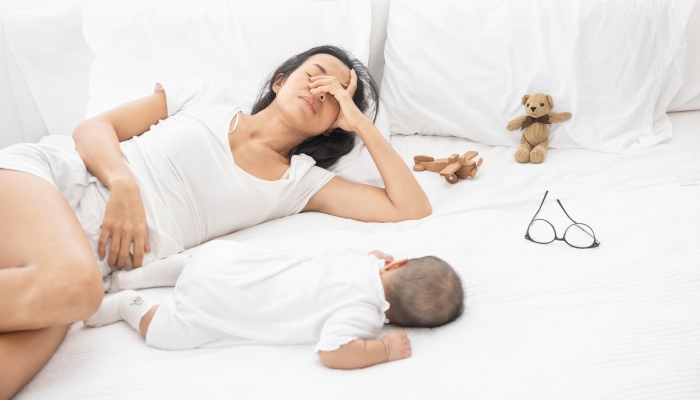 Tired Exhausted Mother Sleeping Sleep With Baby On White Bed.