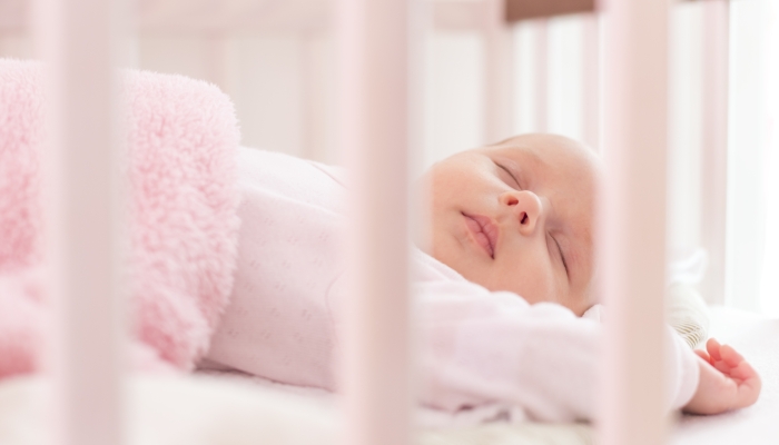 beautiful newborn sleep in crib.