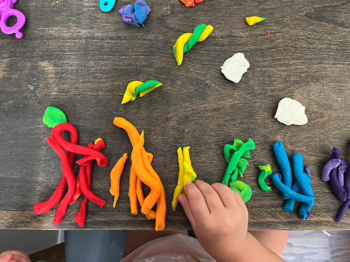 Sorting colors in your rainbow playdough cutting station.