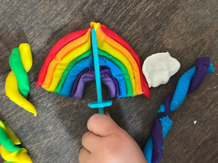 Slicing playdough in your rainbow playdough cutting station.