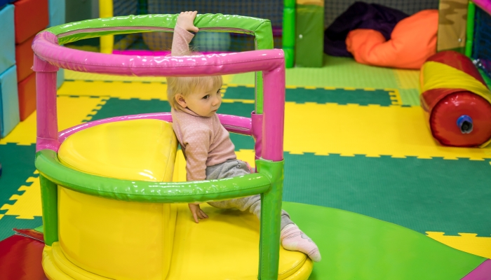 ride on a spinning swing in the children's playground.