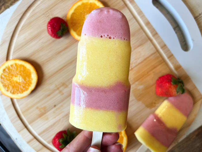 Strawberry orange coconut popsicles.