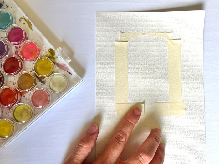 Use tape to create an outline for your watercolor popsicle painting.