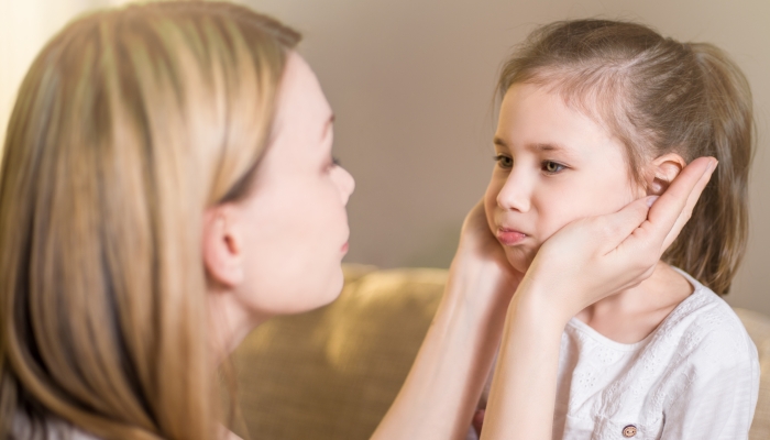 Beautiful mother is comforting his young frustrated daughter.