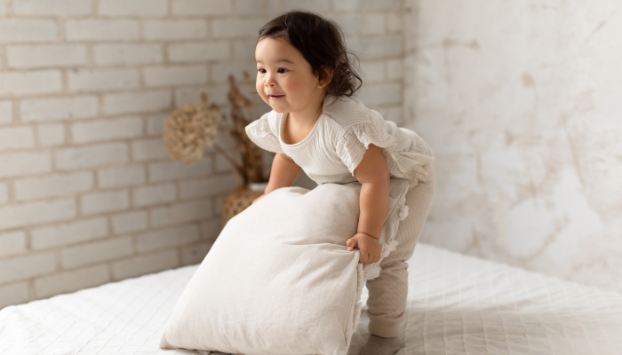 Cute Japanese Little Baby Girl Holding Pillow.