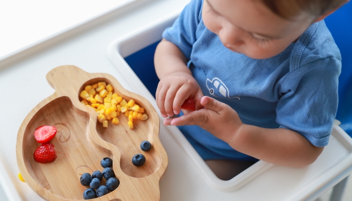 Finger food mix fruit plate strawberry, blueberry and corn.