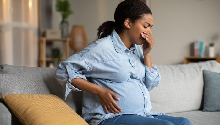 Pregnant Black Lady Suffering From Nausea Holding Hand Near Mouth.