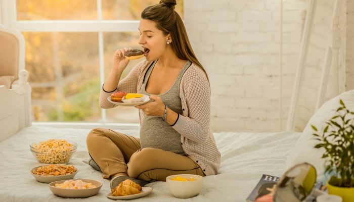 The woman eating a lot of sweets while pregnancy.