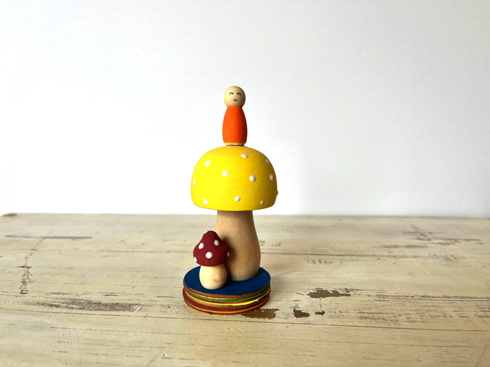 Stacking the mushrooms and peg dolls.